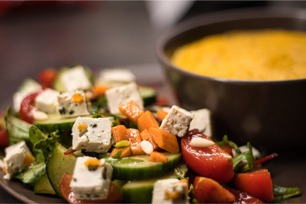 Fresh vegetable salad with feta cheese and a bowl of soup - Ophiuchus Healing Center